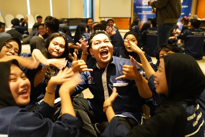 Cheerful participants playing a group game during a workshop
